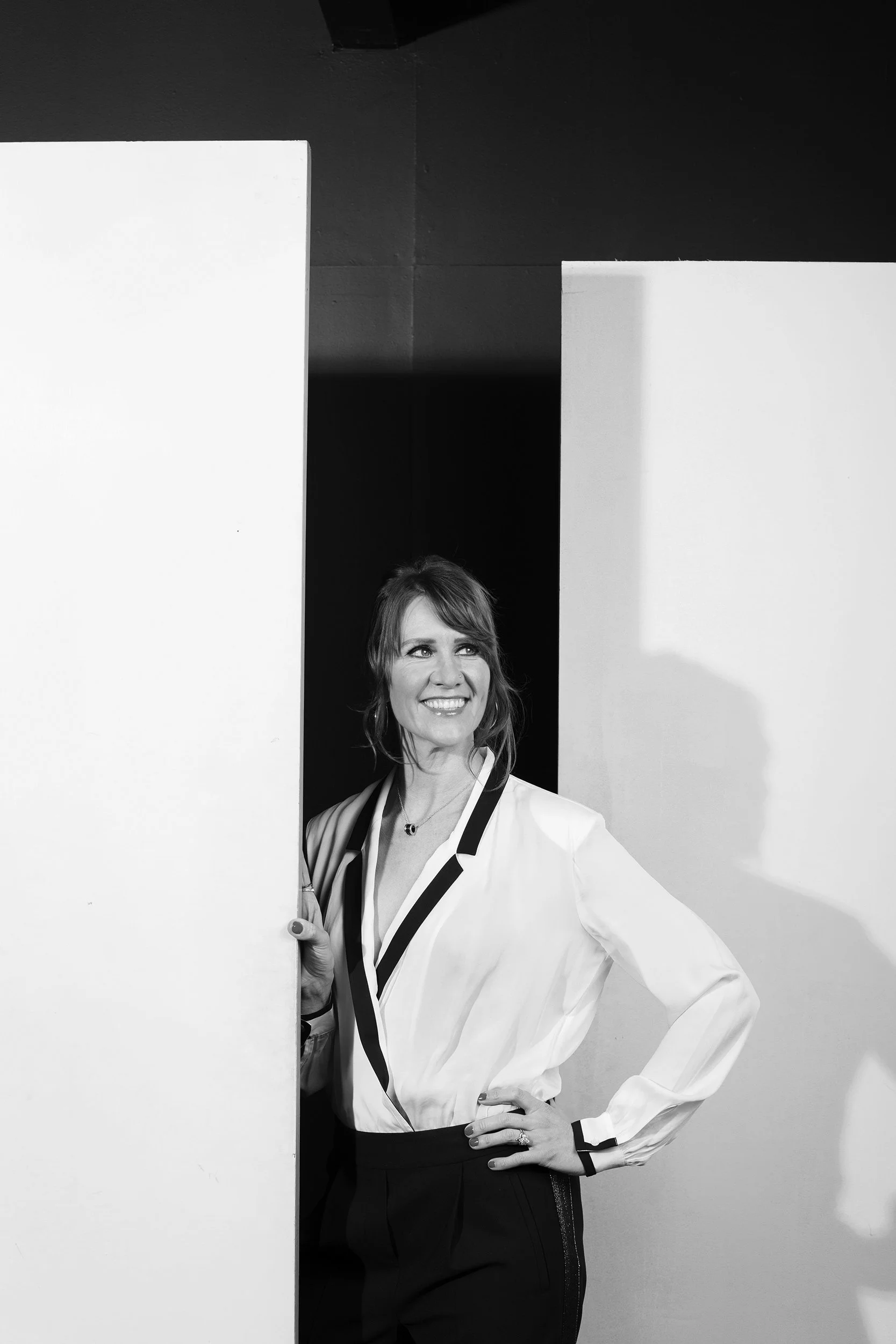 Black and white photo of Sarah Waddington, standing.