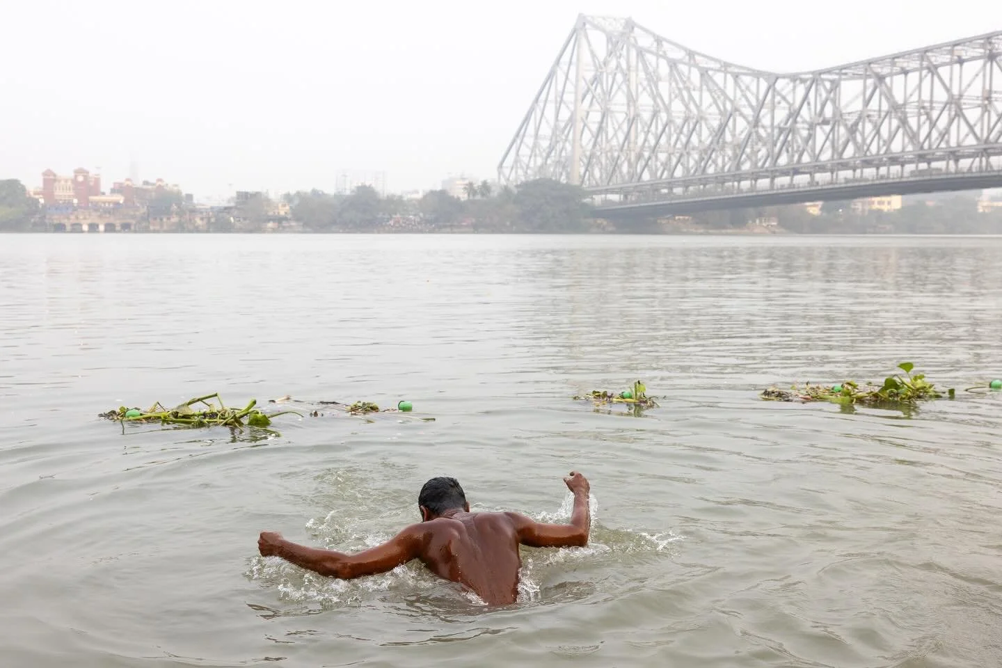 The Howrah Bridge, an icon of Kolkata that spans the Hooghly River, is what most people see first on arriving at Mullick Ghat. 

What held my eye in the early morning light was the solitary man bathing in the river - a deeply time-worn daily ritual t