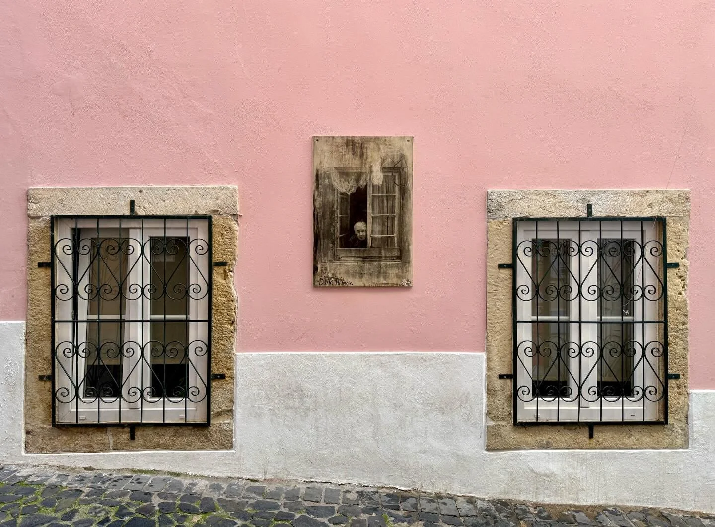In the Alfama district of Lisbon, artist Camilla Watson prints portraits of elderly residents directly onto the walls of the buildings they&rsquo;ve spent their lives in. This is Dona Antonia &ndash; her painted window barely distinguishable from the
