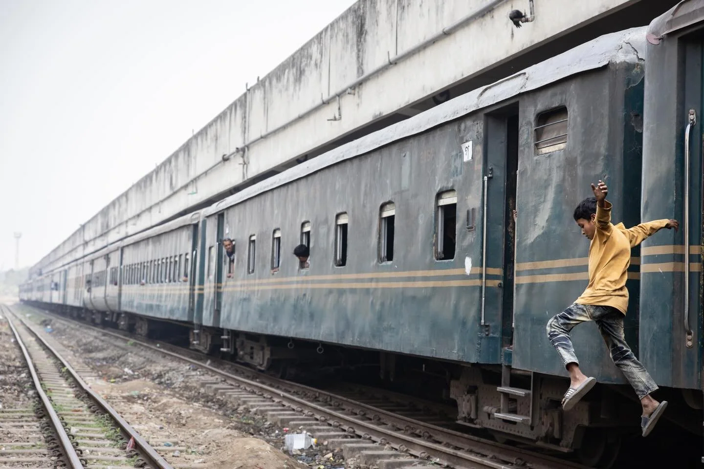 He&rsquo;d been swinging from the door, playing his audience, then vanished. I kept my camera trained on the gap, waiting. A few seconds later he reappeared &ndash; mid-air, grinning. 

The street kids of Dhaka&rsquo;s railway stations are fast, funn