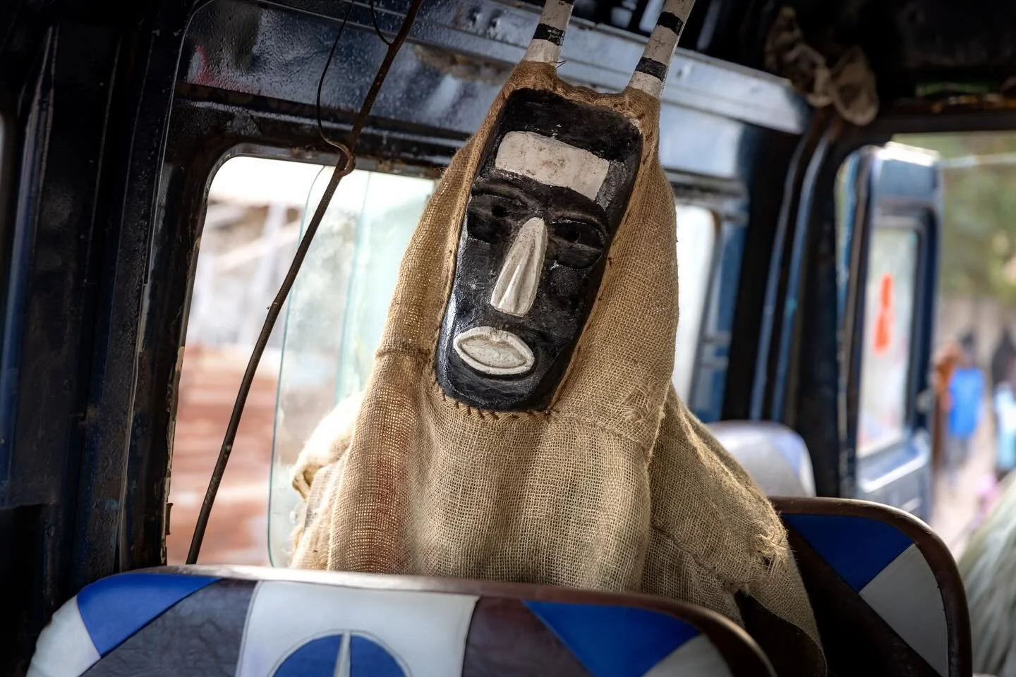The Samay is one of three traditional figures in the mythology of the Jola people of The Gambia and Senegal. Wielding a stick, he maintains order in the community and is believed to know everything that happens in a village. Several times a year he p