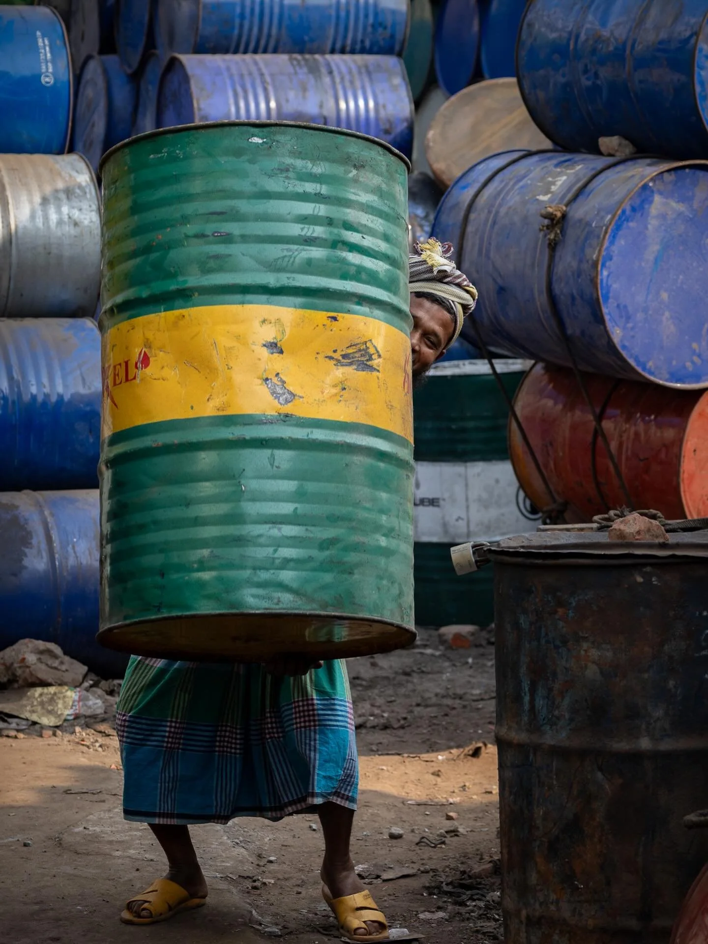 Somewhere behind that drum is a man. 

Oil Drum Recycling Yard, Dhaka, Bangladesh 2026

#myjourneywithacamera #documentaryphotography #dhaka #travelphotography #workinglife