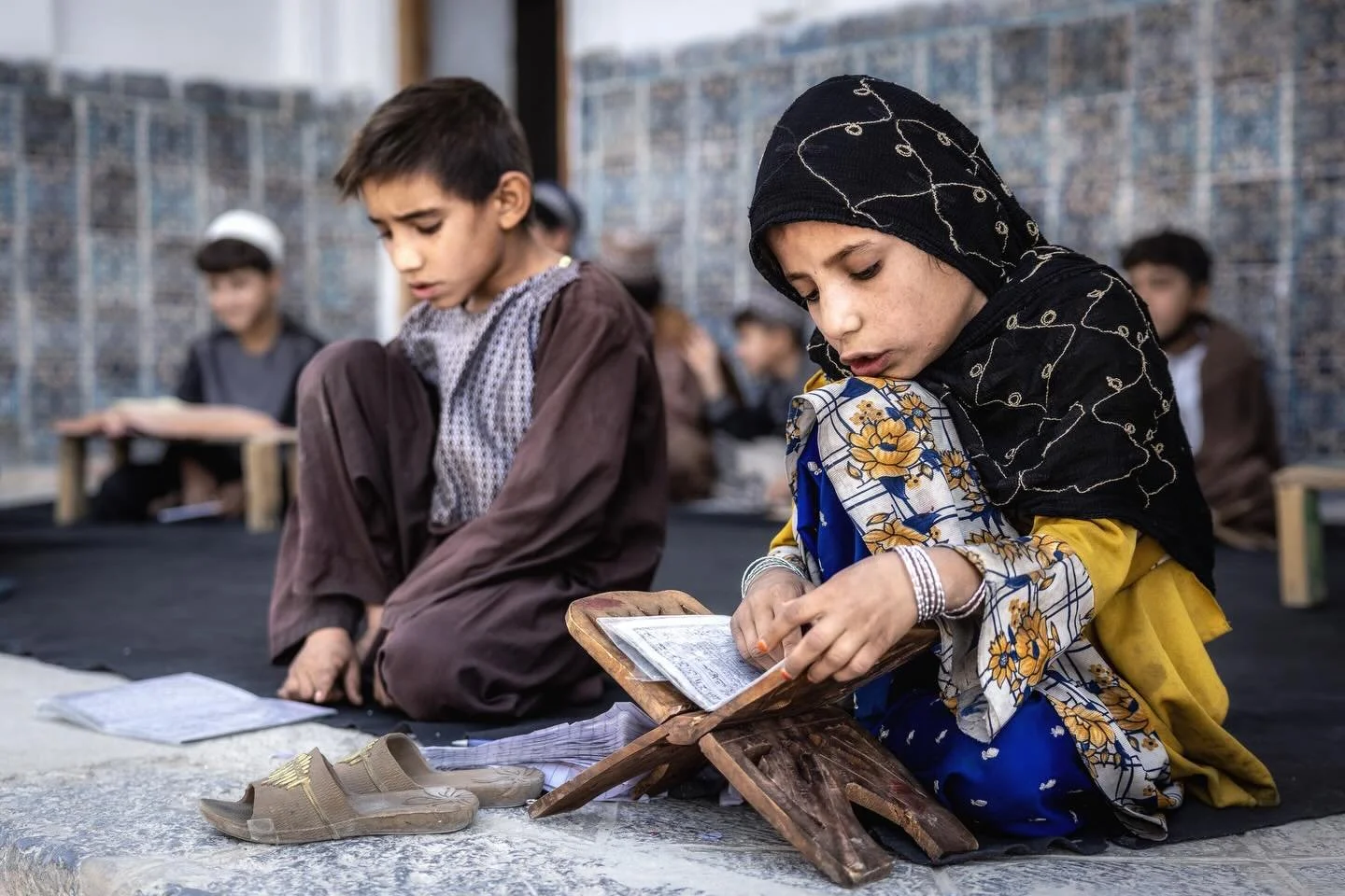 At the Mausoleum of Ahmad Shah Durrani in Kandahar, a class of children study the Quran. She was the only girl among them. 

Afghanistan 2025

#myjourneywithacamera #documentaryphotography #afghanistan #travelphotography #humanstories