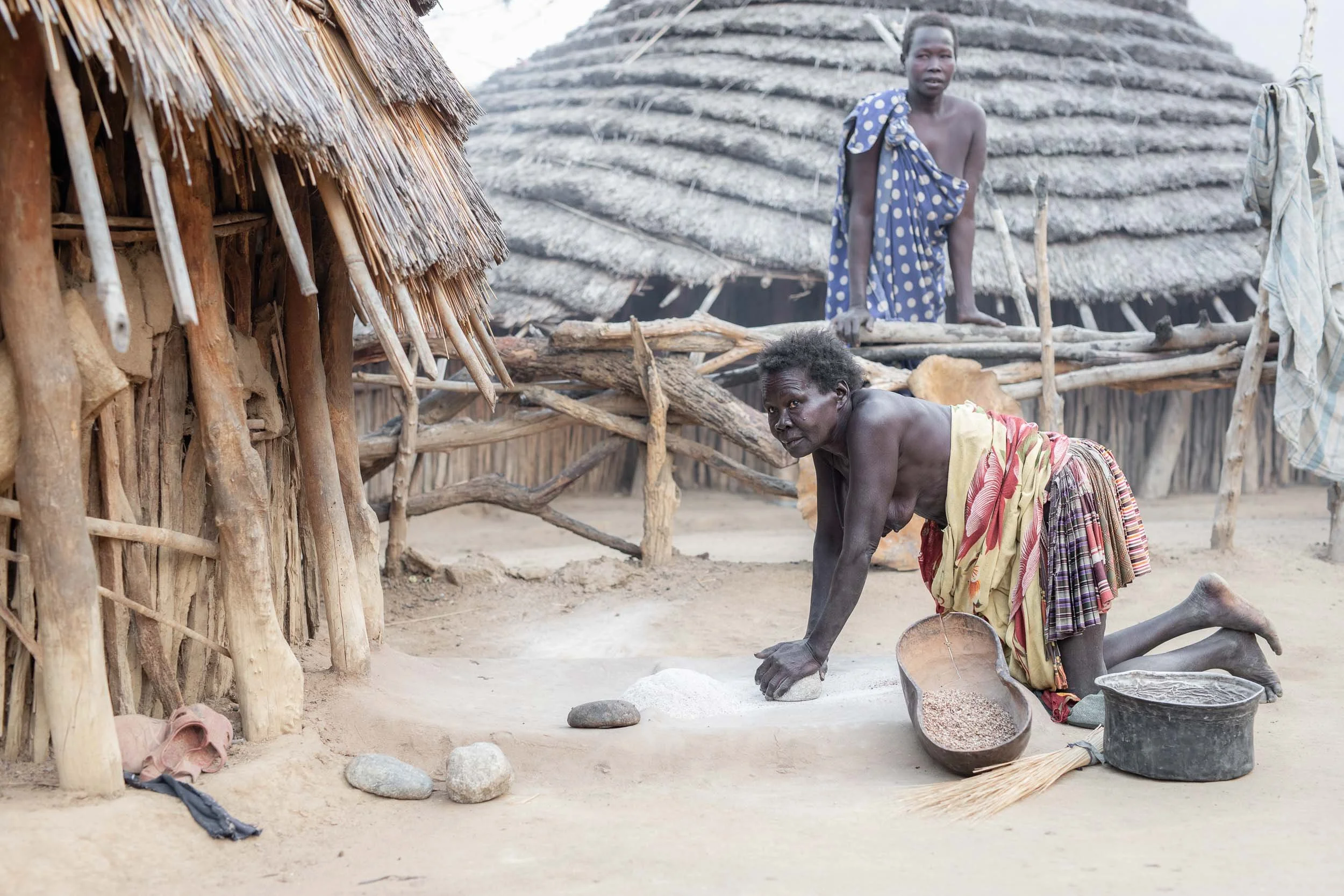 Laarim woman grinding sorghum, South Sudan