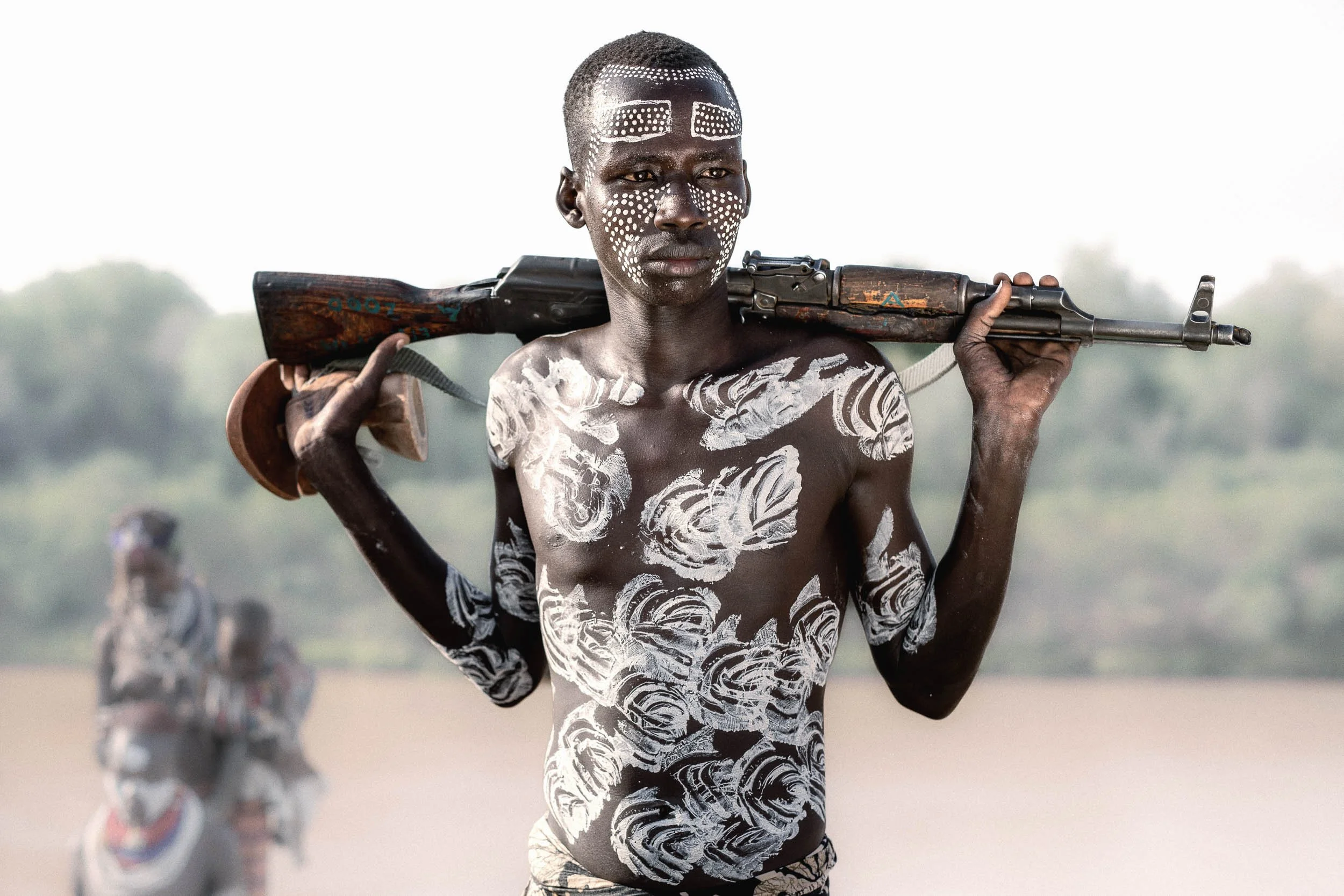 Karo herdsman with rifle on shoulders, Ethiopia