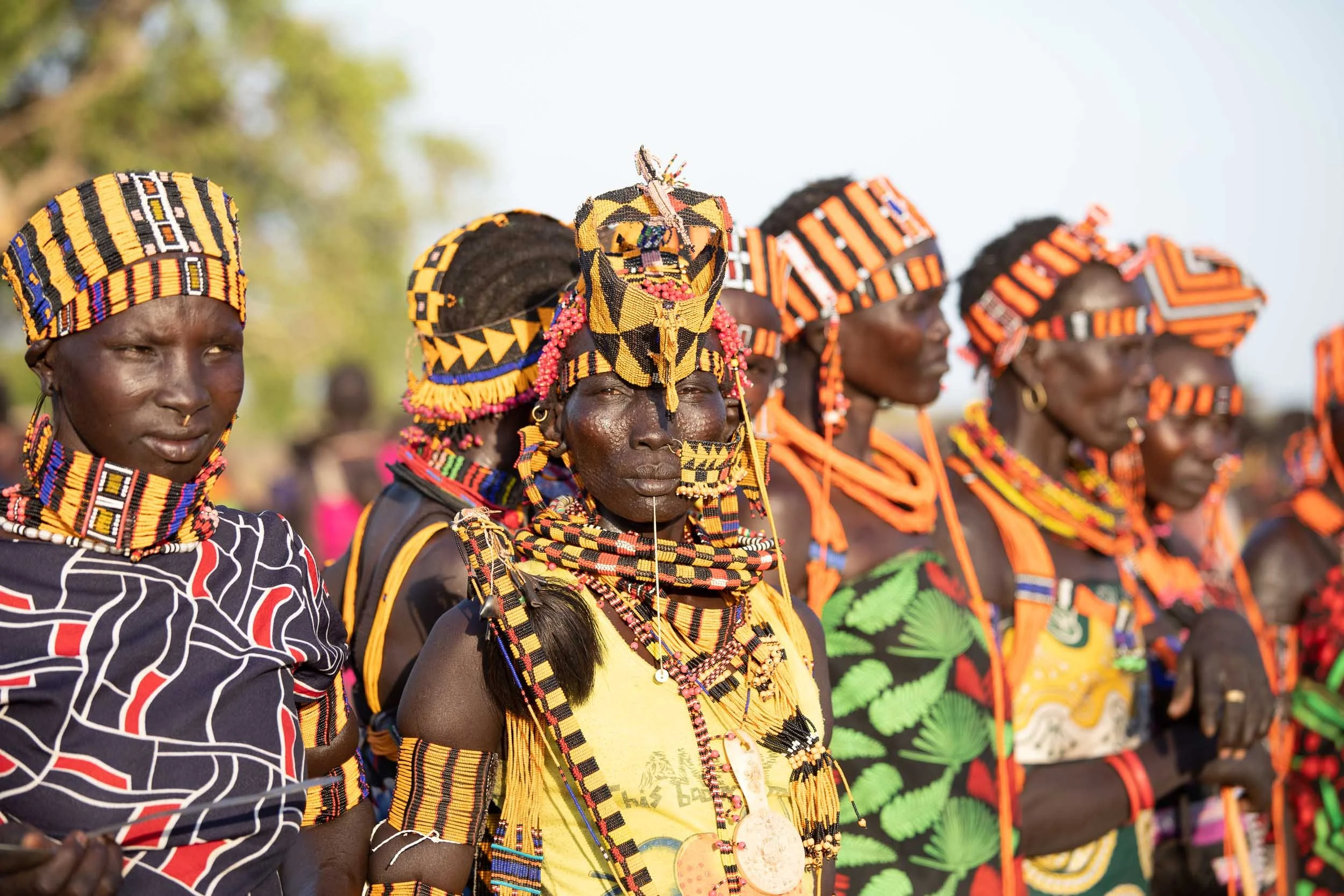 Women in bright, traditional outfits, South Sudan