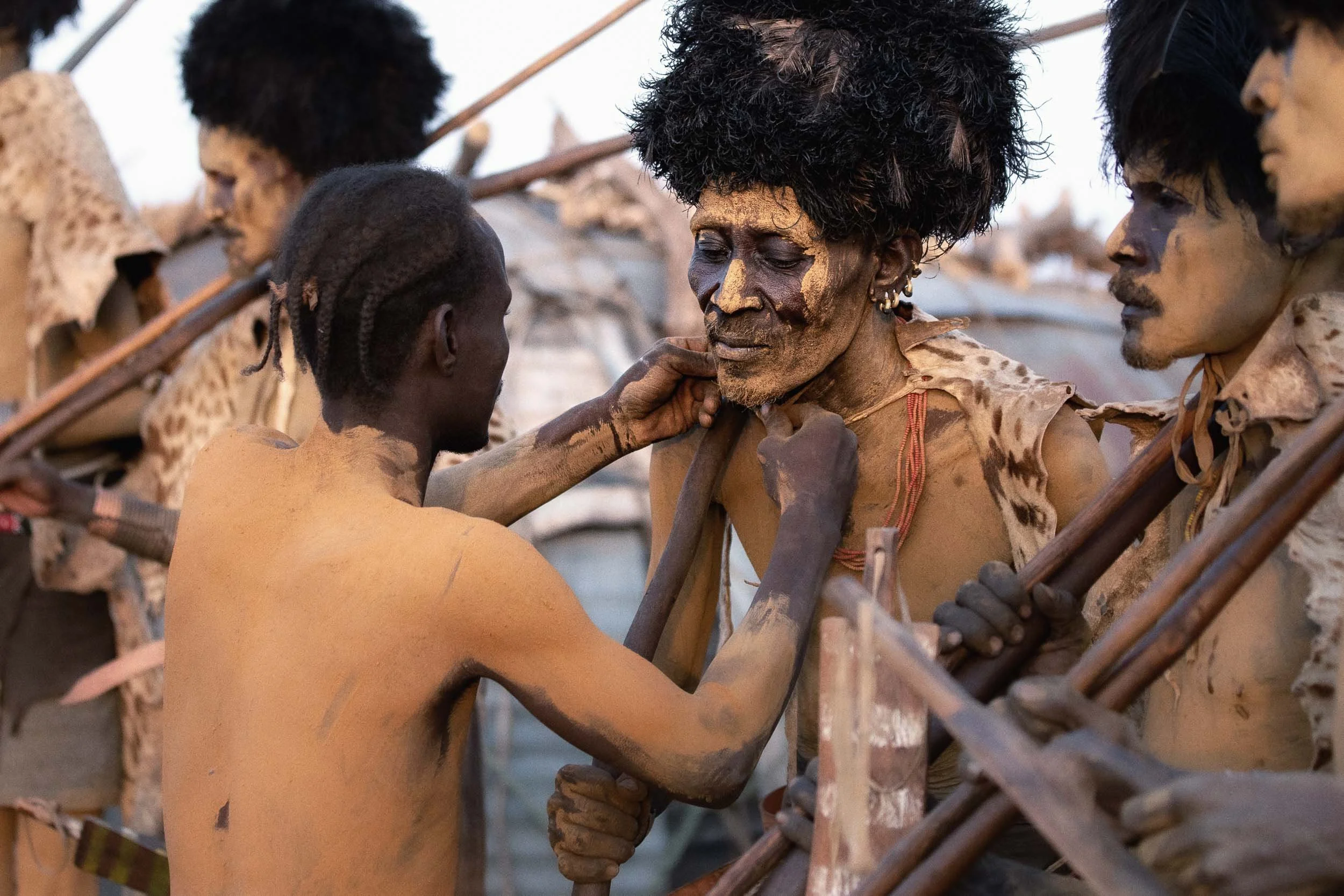 Dassenach man having traditional cloak adjusted, Ethiopia