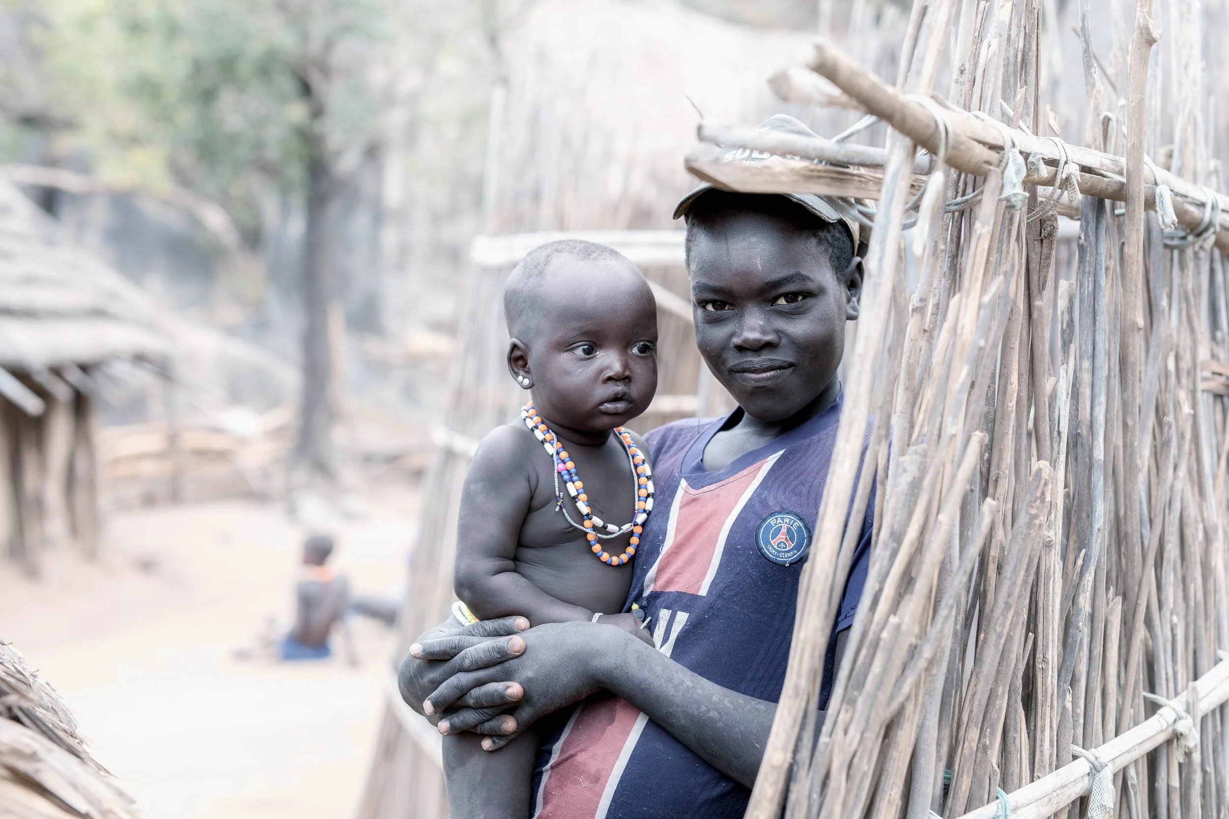 Laarim boy holding his baby sister, South Sudan