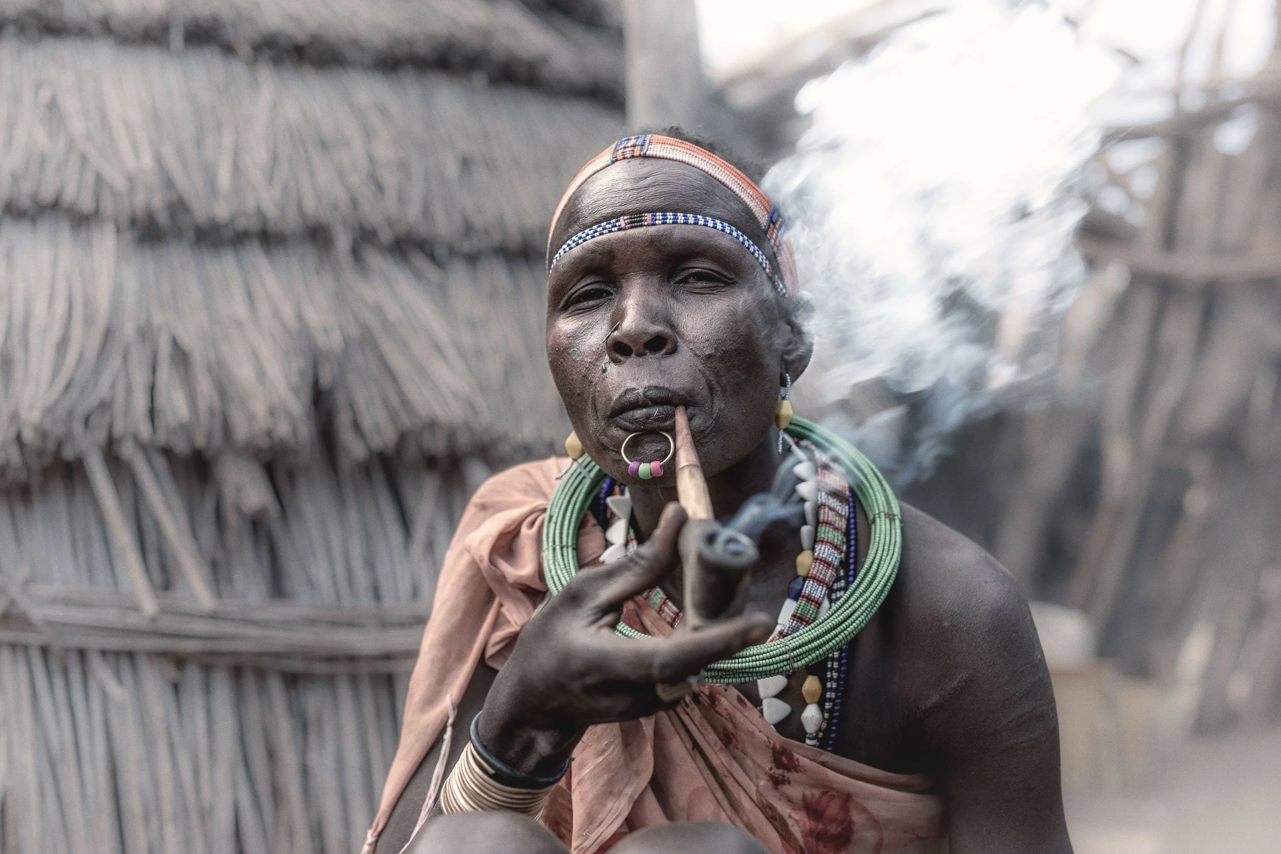Woman smoking pipe, South Sudan