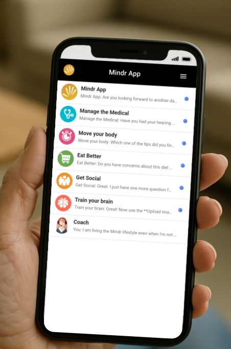 Hand holding a smartphone displaying the Mindr app with options for managing health, body, social life, brain training, and coaching.