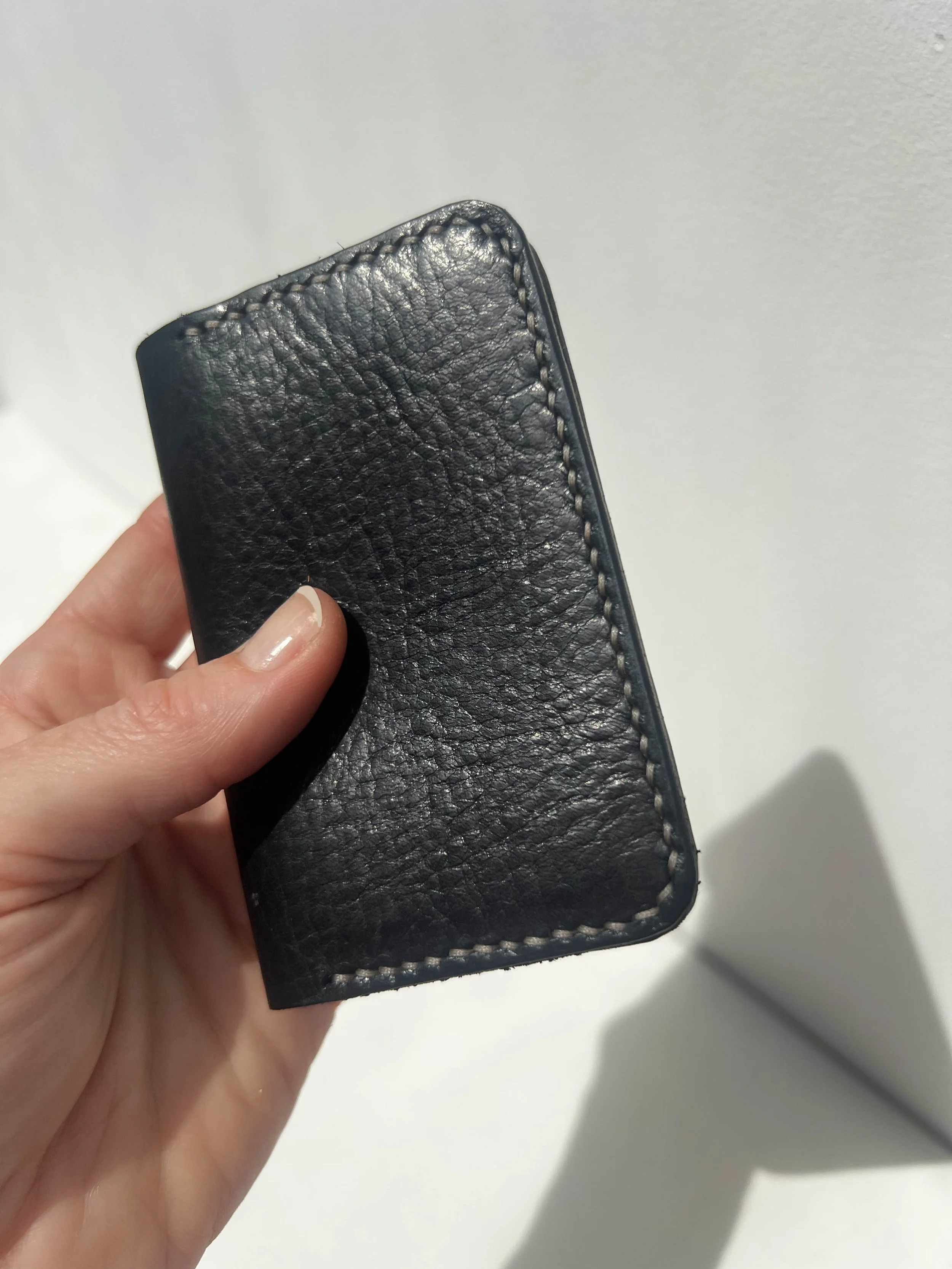 cardholder black in the hand.jpg