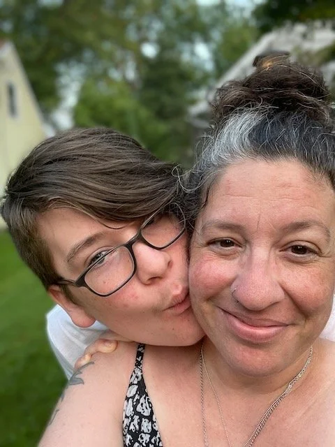 Photo selfie of Marissa and her son, in from of their home