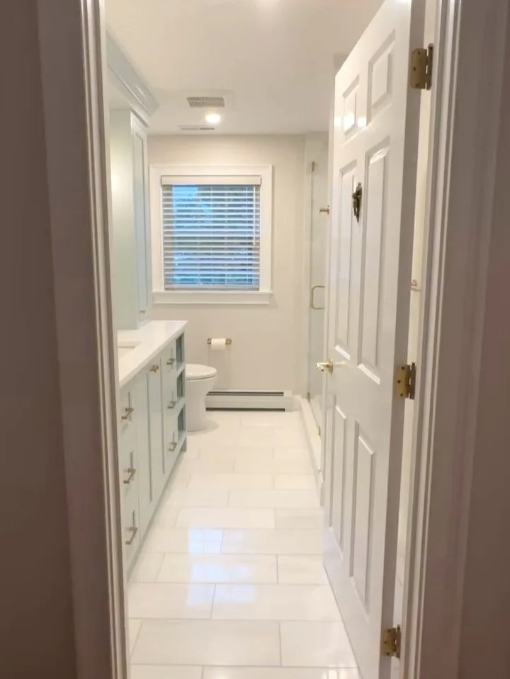 Our Marblehead bathroom renovation is now complete and the transformation is nothing short of exceptional. Rebuilt from the ground up, the space features brass fixtures, exquisite marble tile, and a custom vanity finished in Smoke by @benjaminmoore &