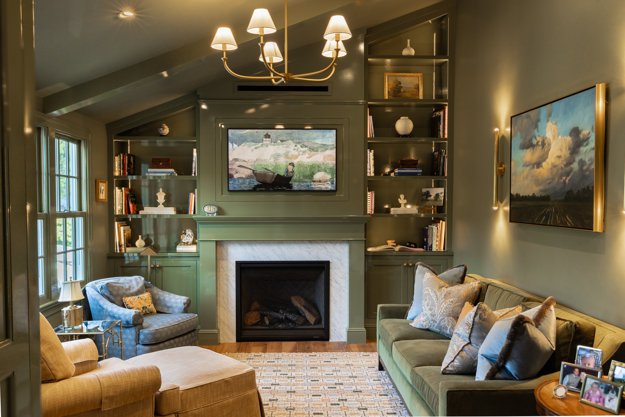 Sunroom painted with green walls and built in cabinets