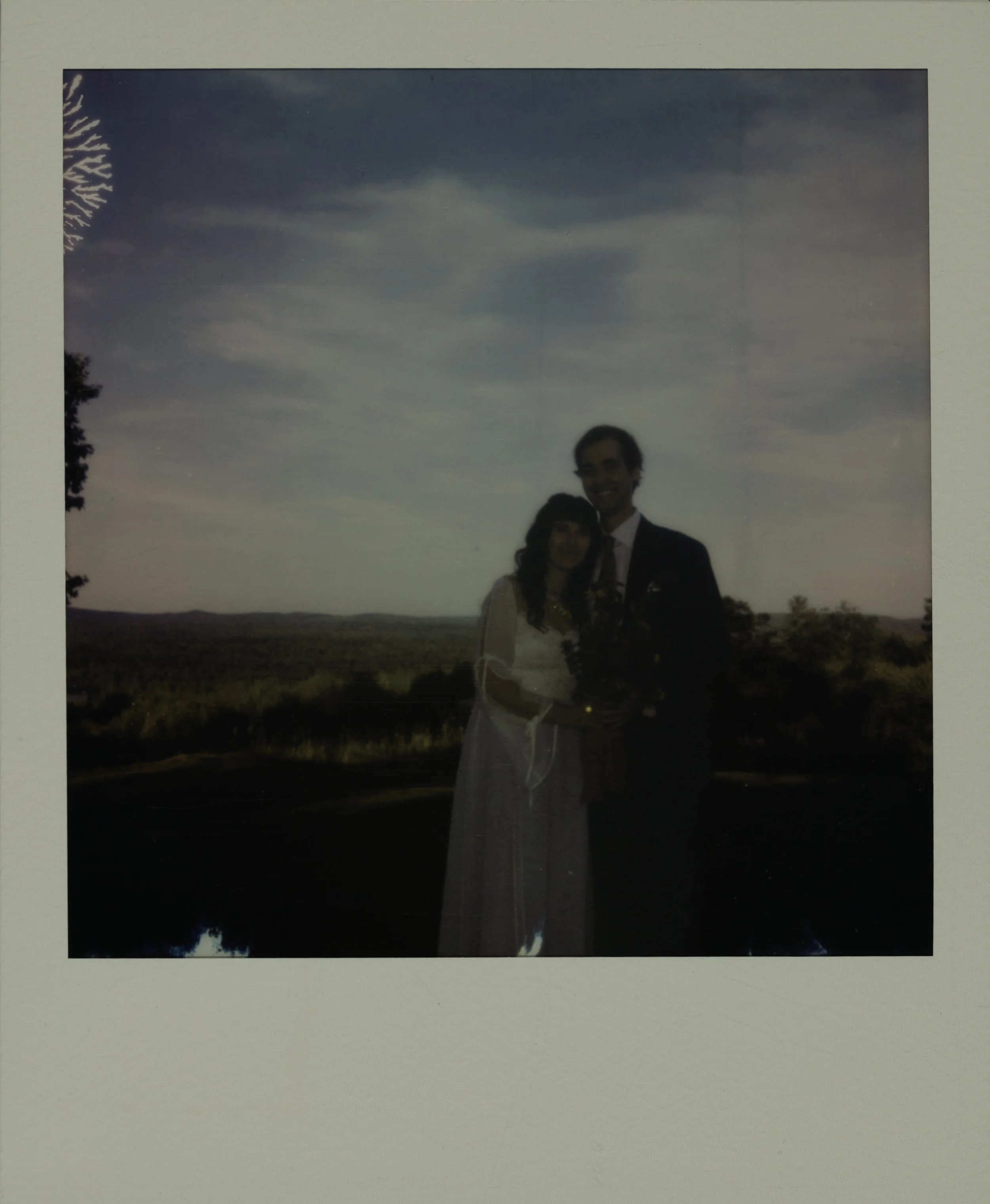 Polaroid print of couple Alec and Ally on their wedding day in September over looking mt Washington