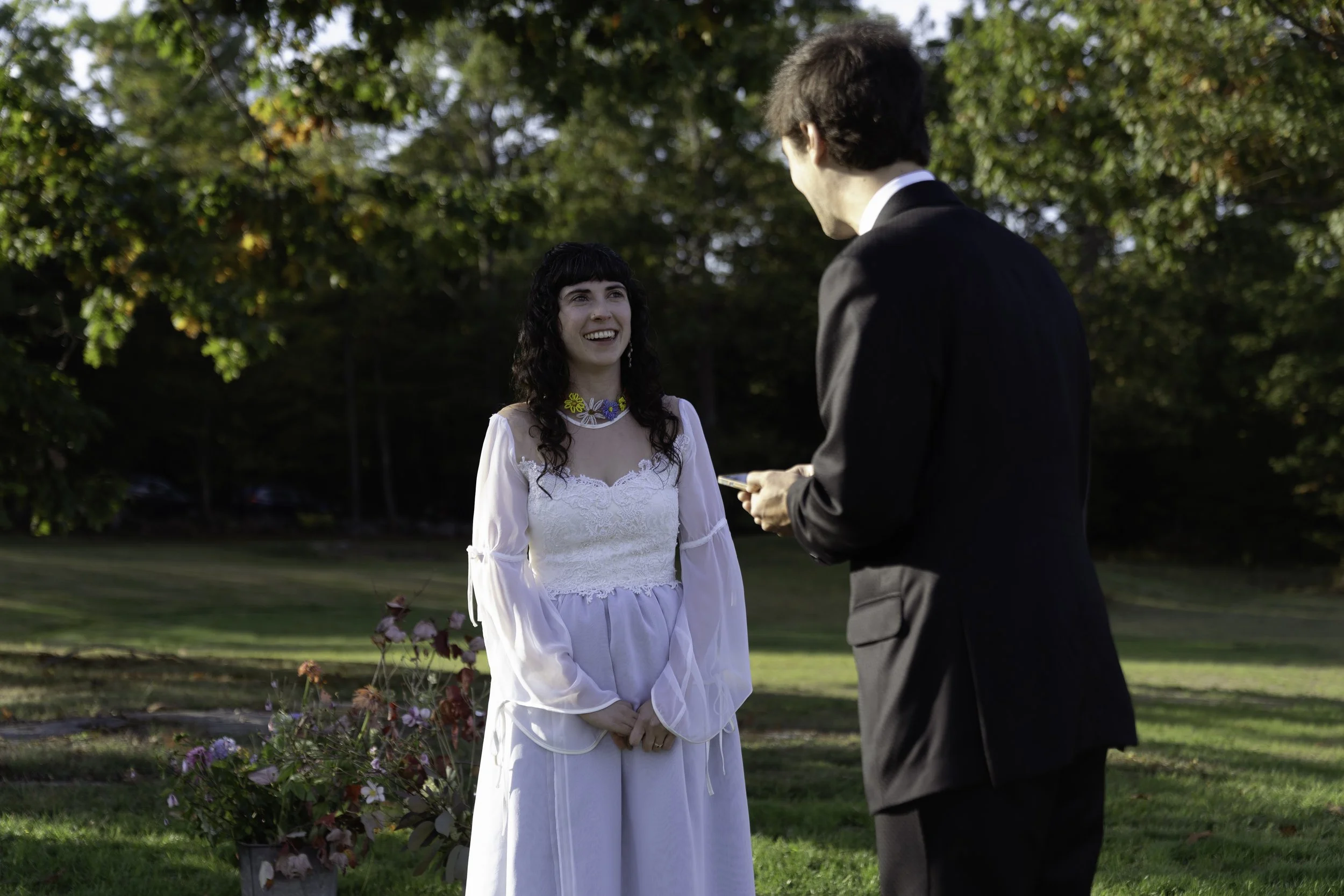 Bride and groom standing across from eachother at their marital altar in Northern Maine.