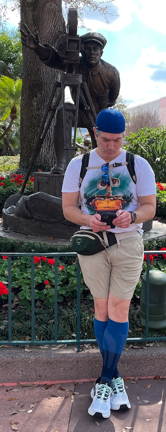 Brandon Pico with a camera, standing beside a filmmaker statue