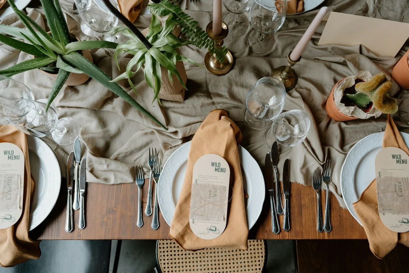 Overhead view of an elegant neutral rehearsal dinner table setting