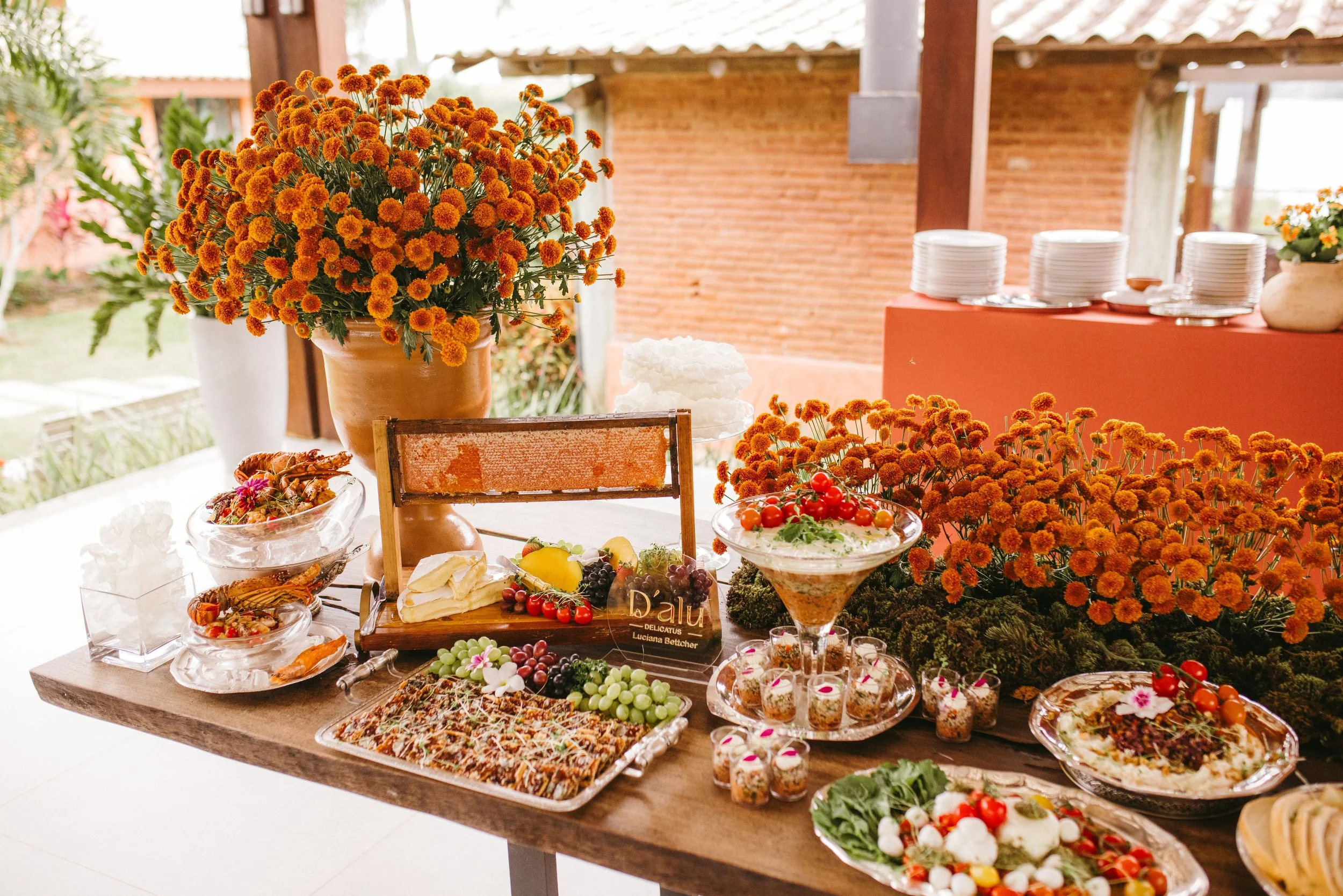 Outdoor wedding buffet with colorful flowers and arranged food