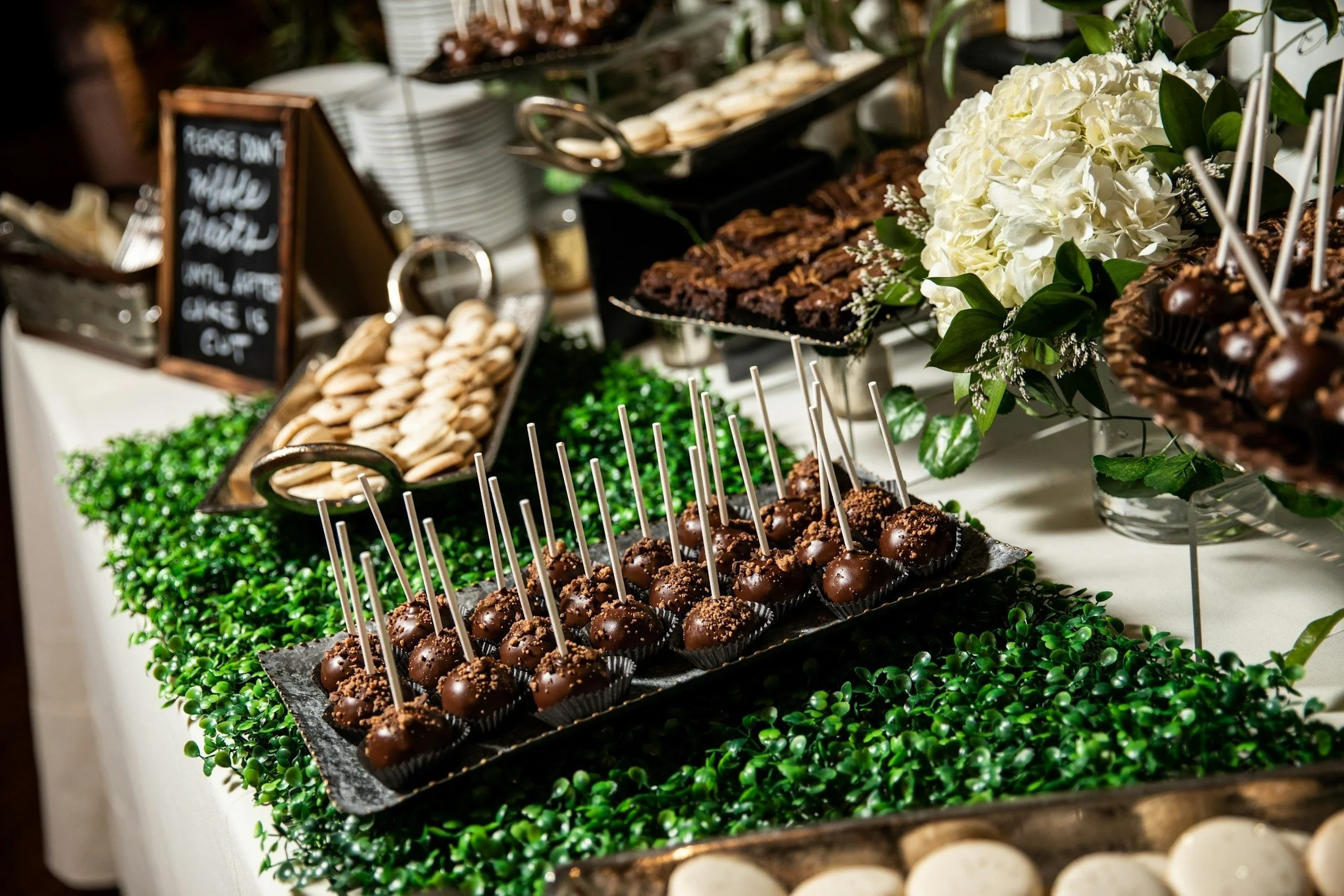 Wedding dessert table with cake and bite-sized sweets