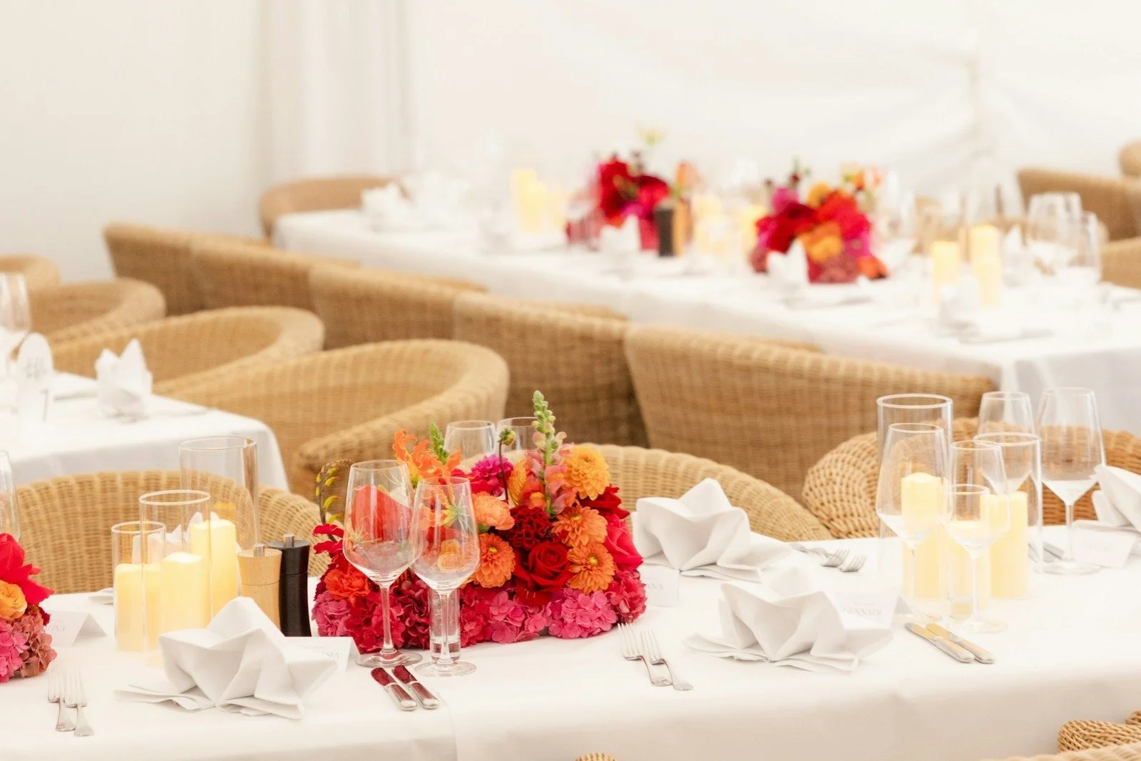 Elegant winter wedding reception centerpiece with candlelight and seasonal greenery