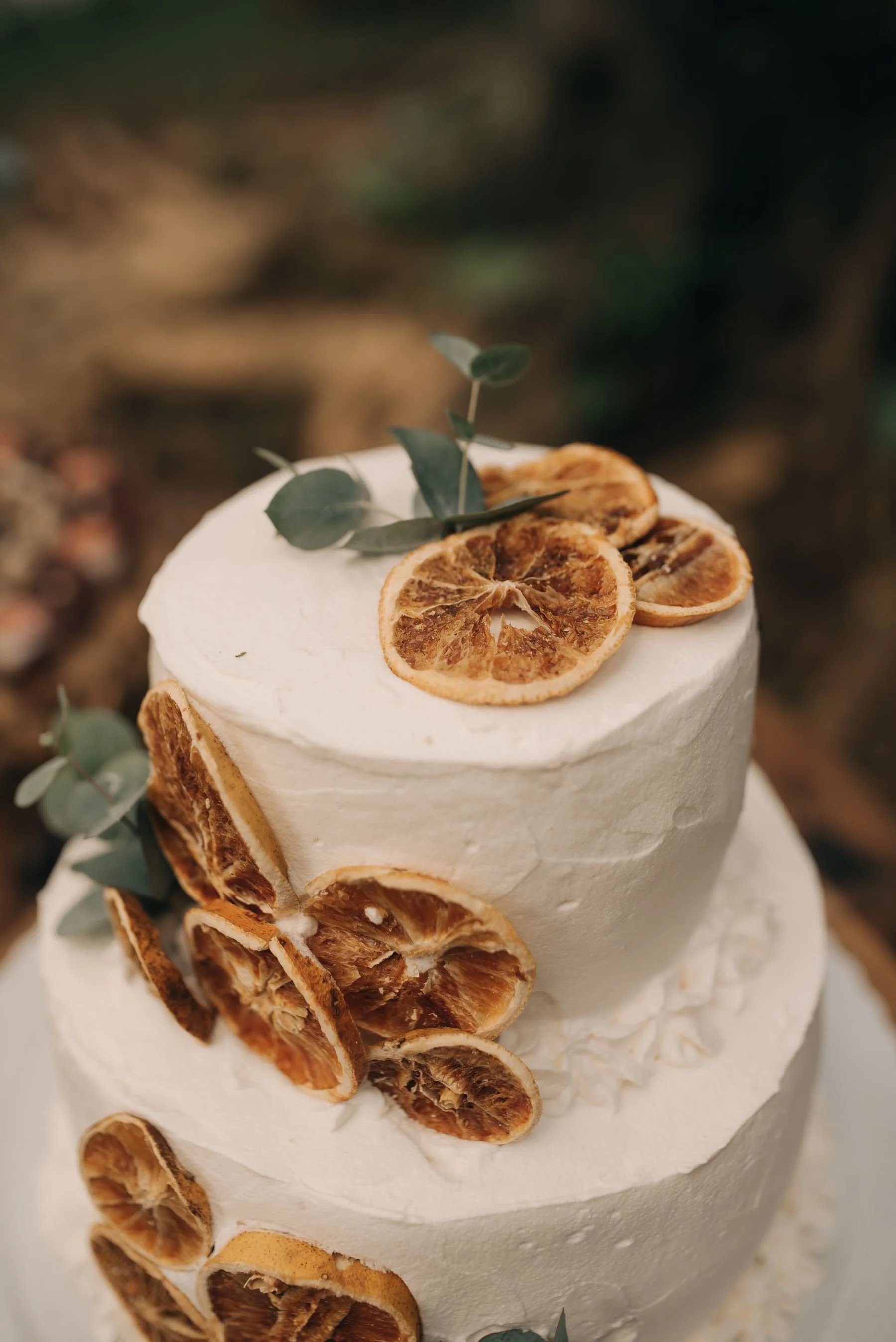 Elegant winter wedding cake with seasonal greenery and candlelight
