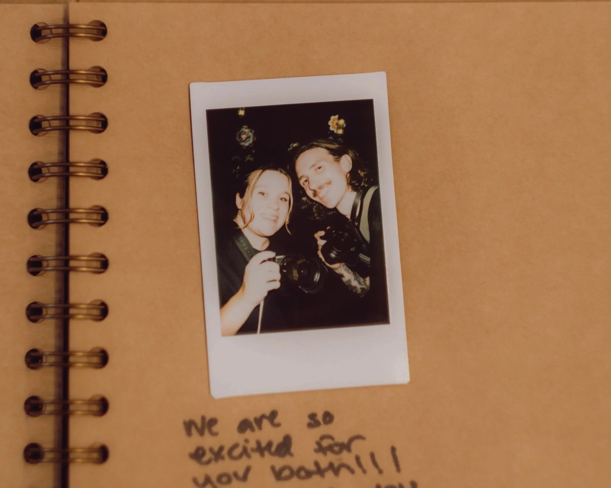 Wedding photographers captured in an Instax photo in the guest book at Sacred Heart Cultural Center wedding in Augusta, Georgia