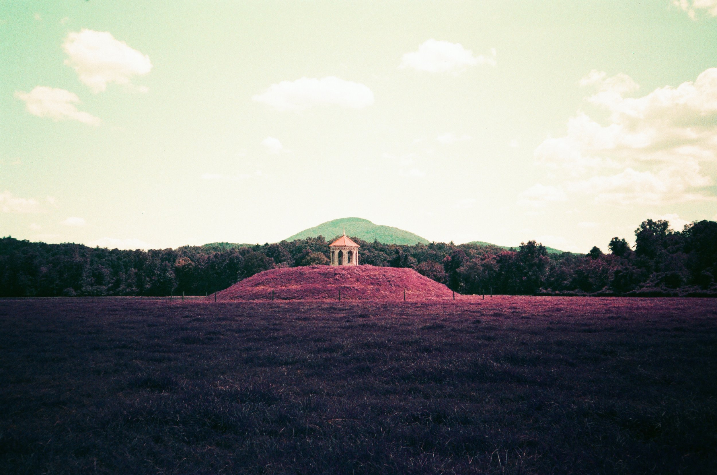 Nacoochee Mound turned purple on LomoChrome Purple film, with its gazebo and Mount Yonah in the distance