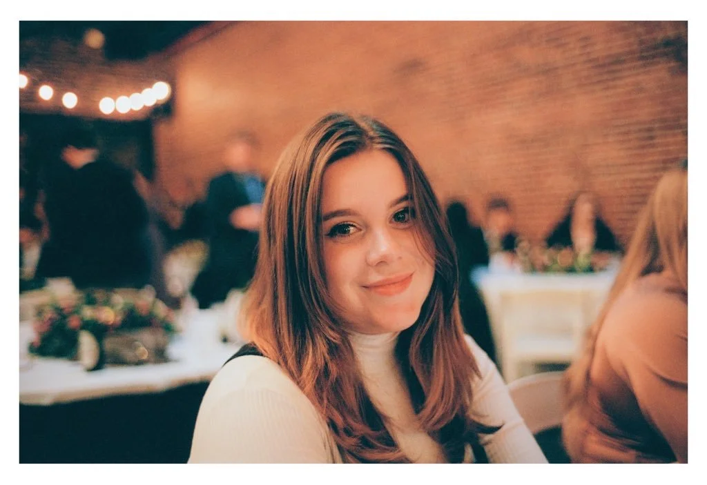 Portrait of a smiling young woman at a candlelit event, shot on a Leica M6