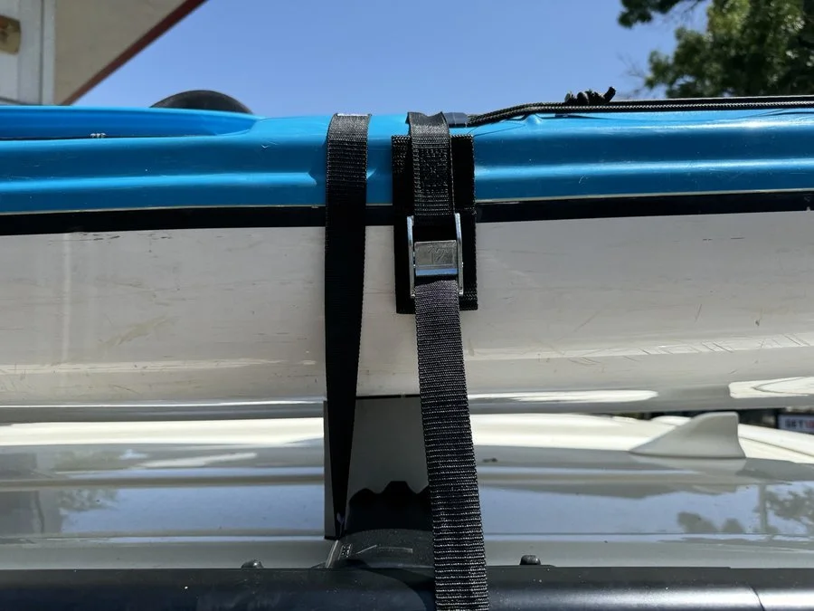 secure kayak with straps and foam blocks on roof rack