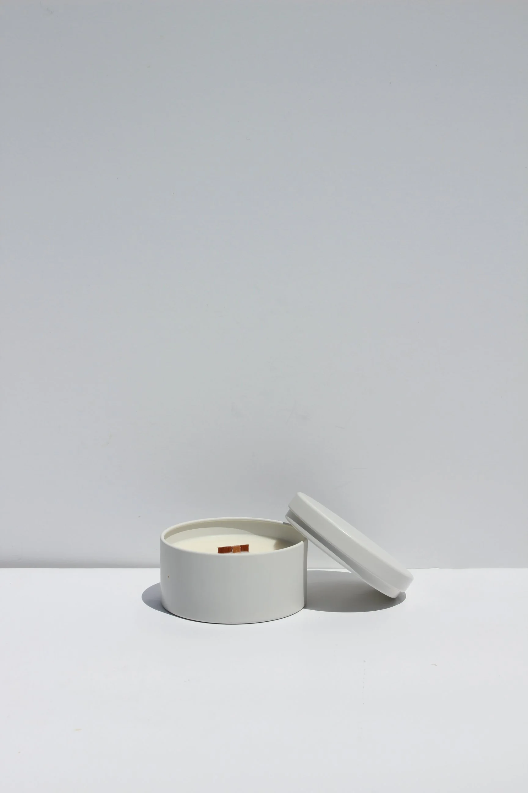 Library soy wax candle in a cream travel tin with wooden wick by Lune et Soleil