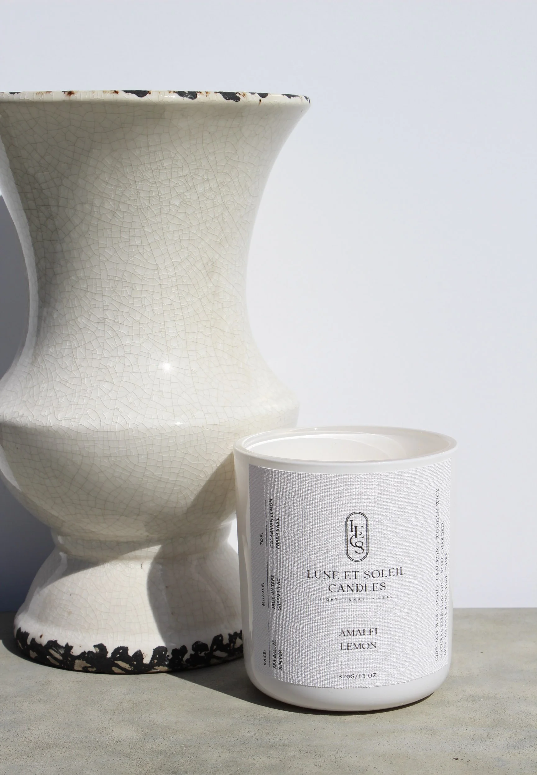 Amalfi Lemon soy wax candle in a white vessel style with a vase by Lune et Soleil