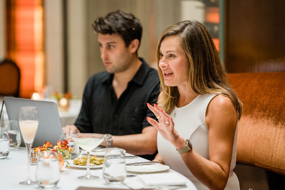 Business Man on Laptop and Woman Speaking at Business Meeting at The Mark Hotel in Manhattan, NY