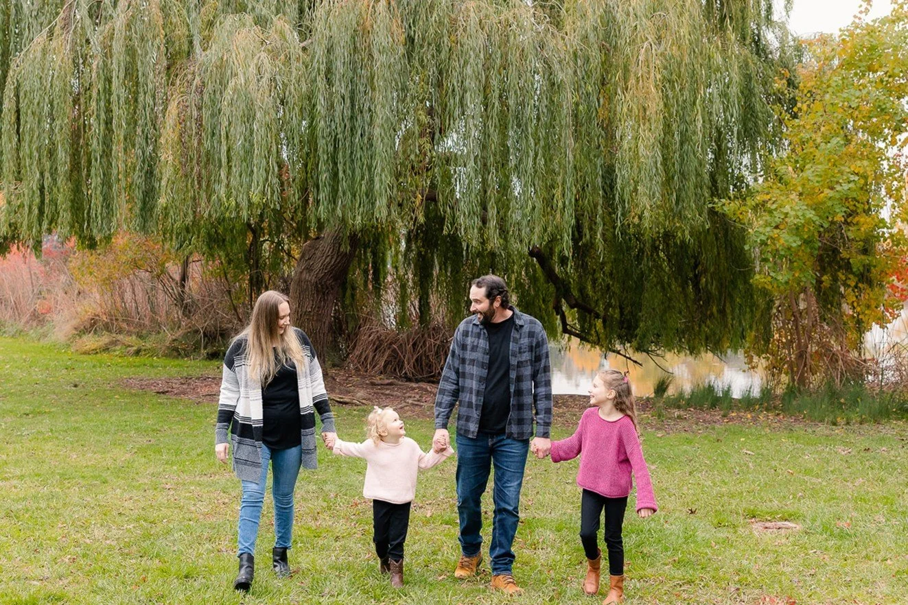Family of four walking together during an outdoor family portrait session in Elk Grove
