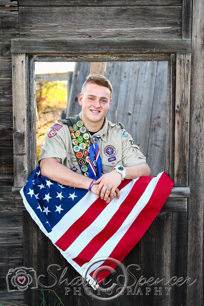  senior guy wearing Eagle Scout uniform with American flag 