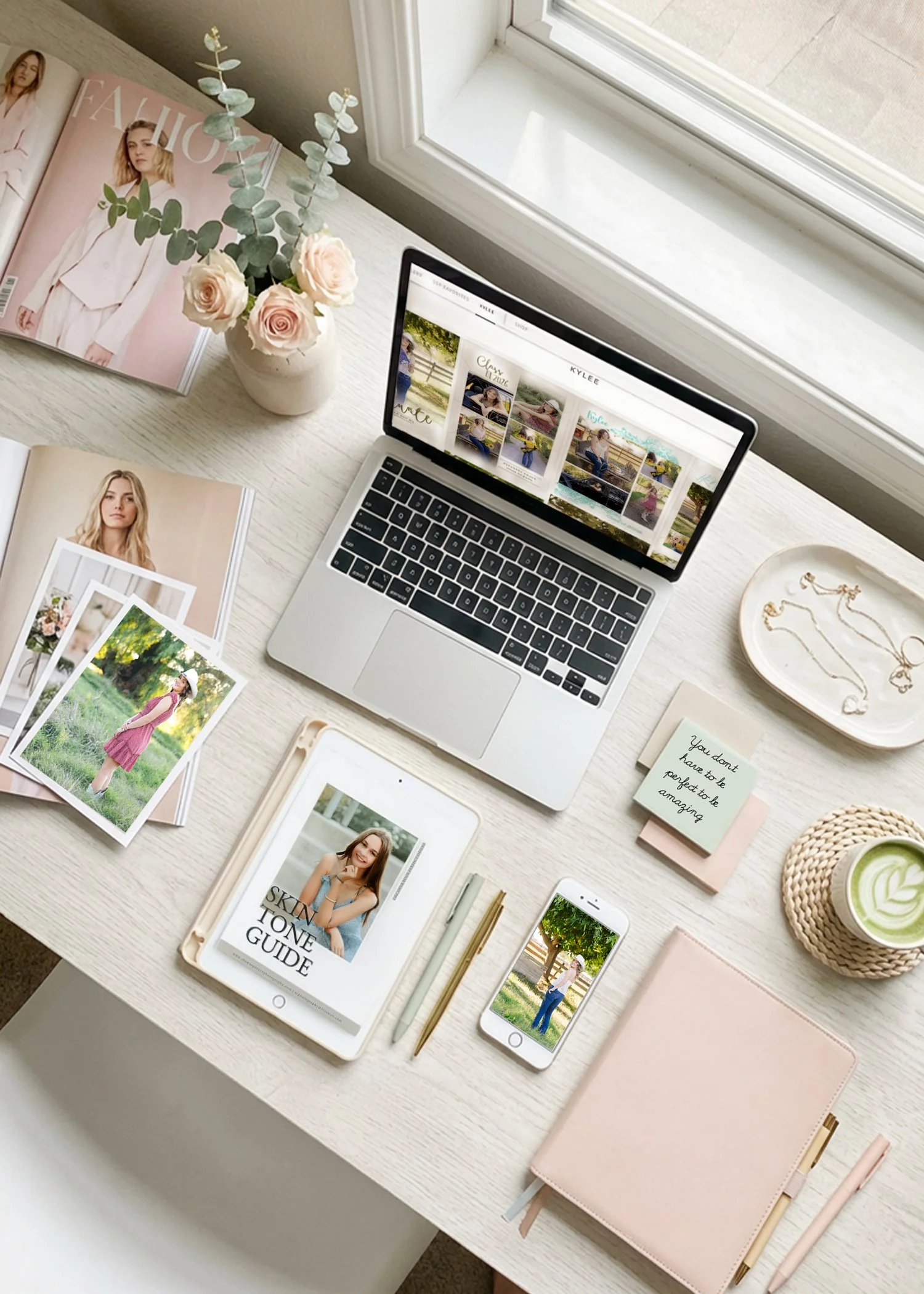 Flat lay desk mockup featuring a laptop, tablet, and phone displaying a senior Skin Tone Guide alongside senior portraits, jewelry, and styled accessories