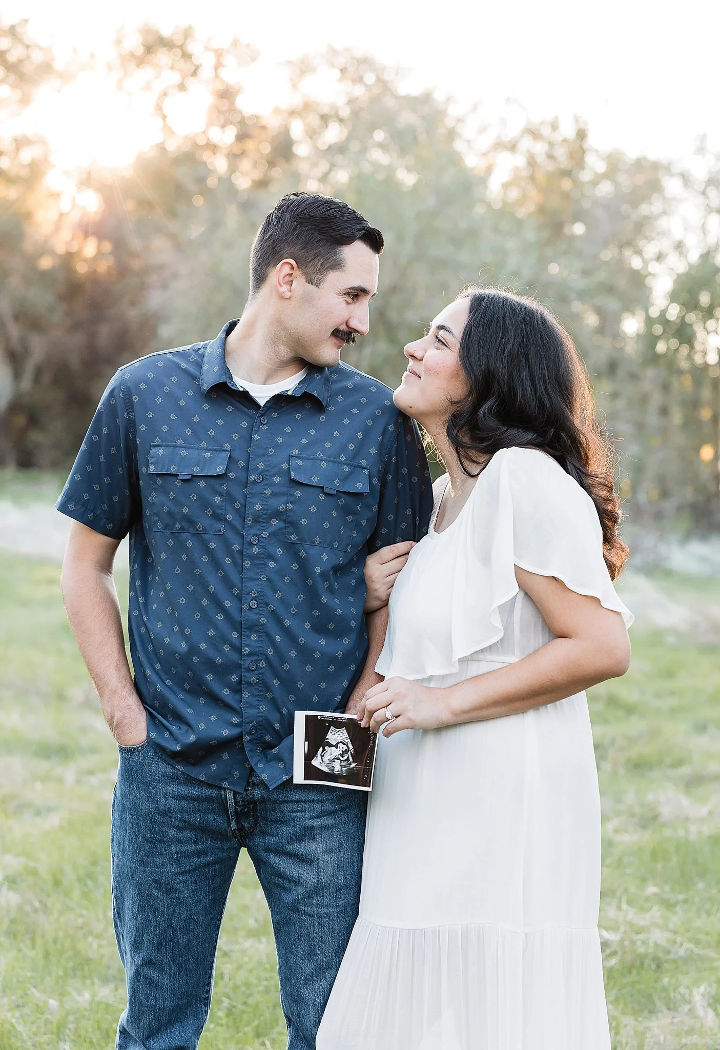 Expecting couple sharing a quiet moment during an outdoor maternity portrait session in Elk Grove, California