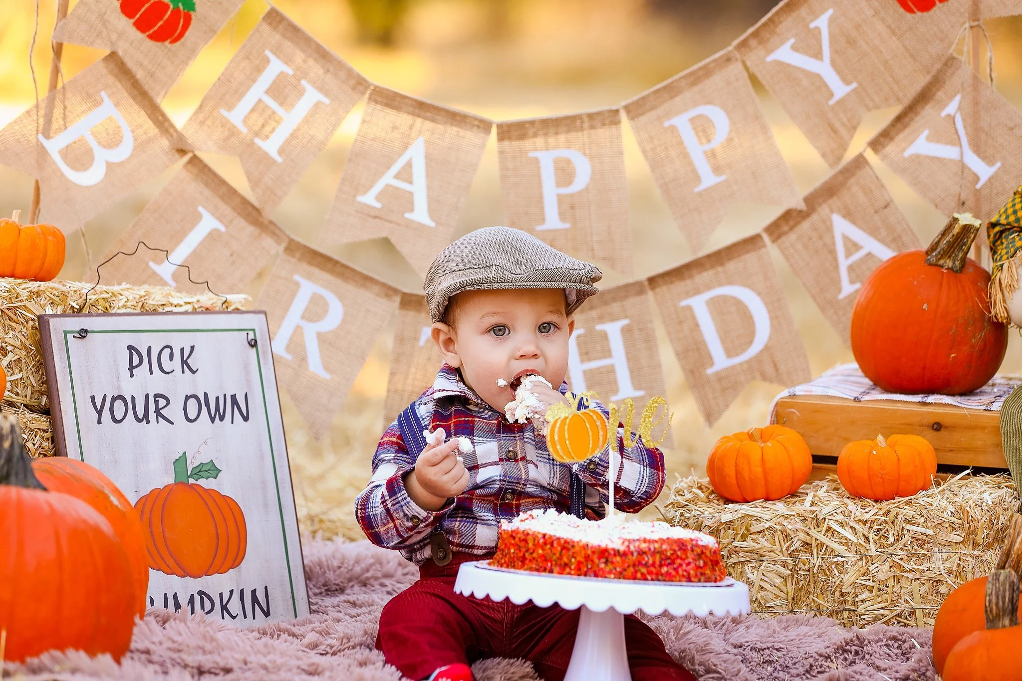 Fall themed first birthday cake smash with pumpkins and burlap birthday banner photographed in Elk Grove, CA.