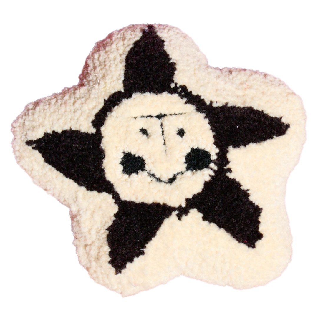 Black and white tufted flower plushie