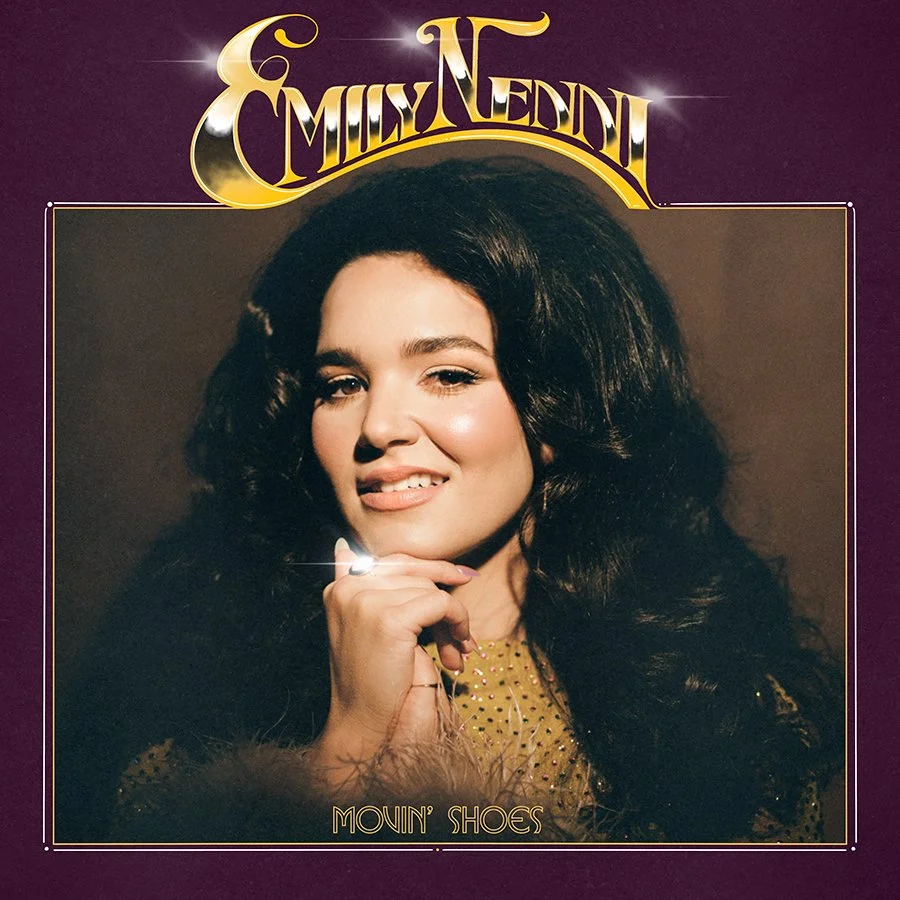 Album cover featuring a woman with long, dark, curly hair, winking and touching her chin with her hand. The background is dark with a gold border, and the text says 'Emili Nedi' at the top and 'Movin' Shoes' at the bottom.