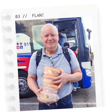 Man standing outside a bus holding four plastic food containers