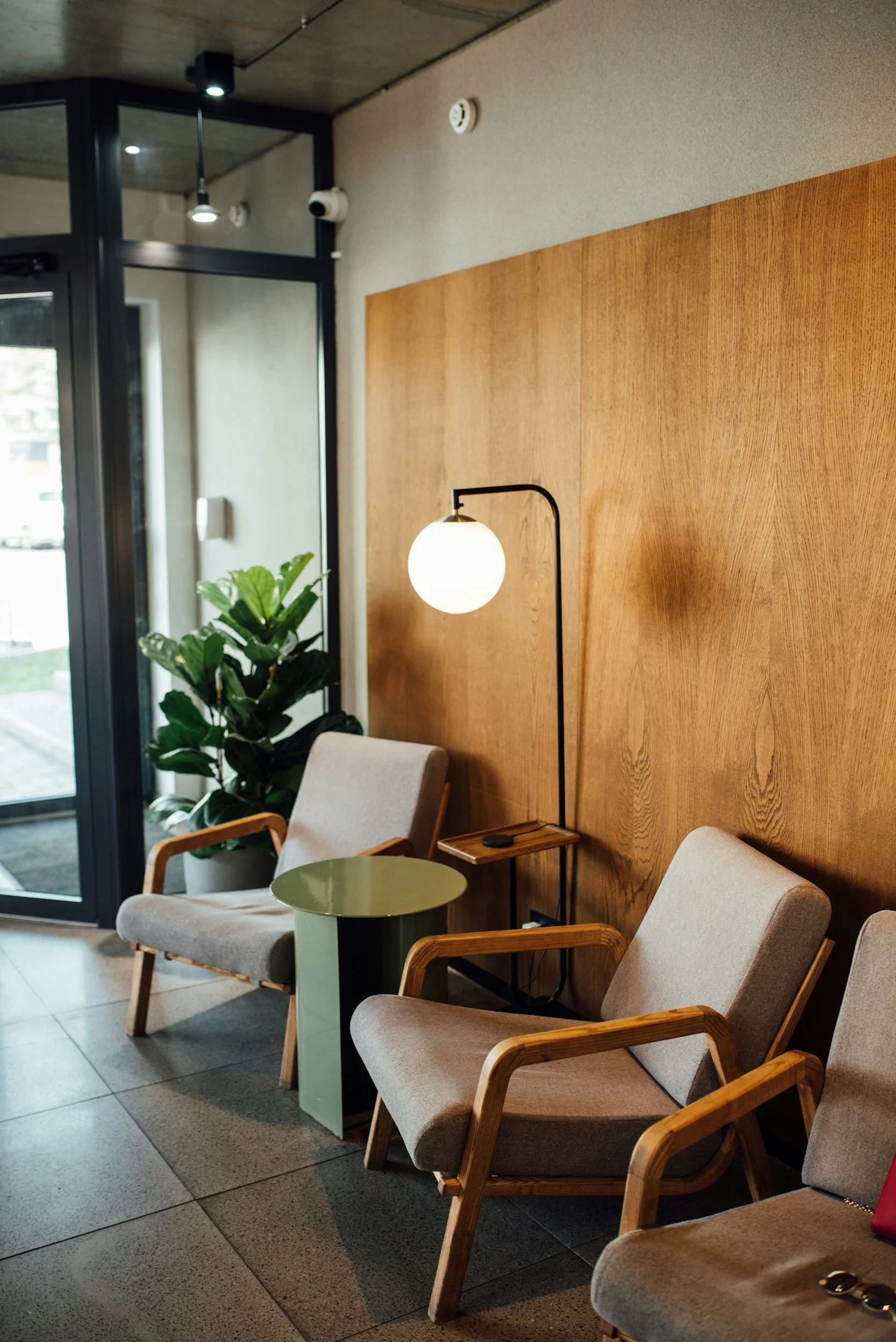 A calm, light-filled therapy office with neutral tones, natural light, and a grounded, intentional atmosphere that conveys focused, trauma-informed healing and emotional safety.