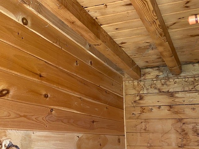Edward Fenton Wood Jr. built the Interior walls and ceiling made of unpainted natural cedar planks and constructed by using the "tongue-and-groove" joint construction. A tongue and groove joint is a type of woodworking joint that simplifies the insta