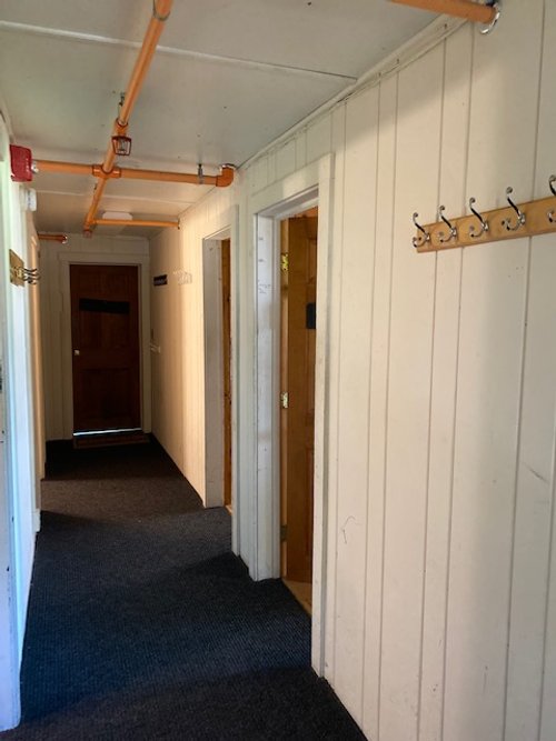 Woods House entry hallway to the dormitory rooms. The wall at the end will house the "Cedar Memorial" hand carved by his son, Edward Fenton Wood III.