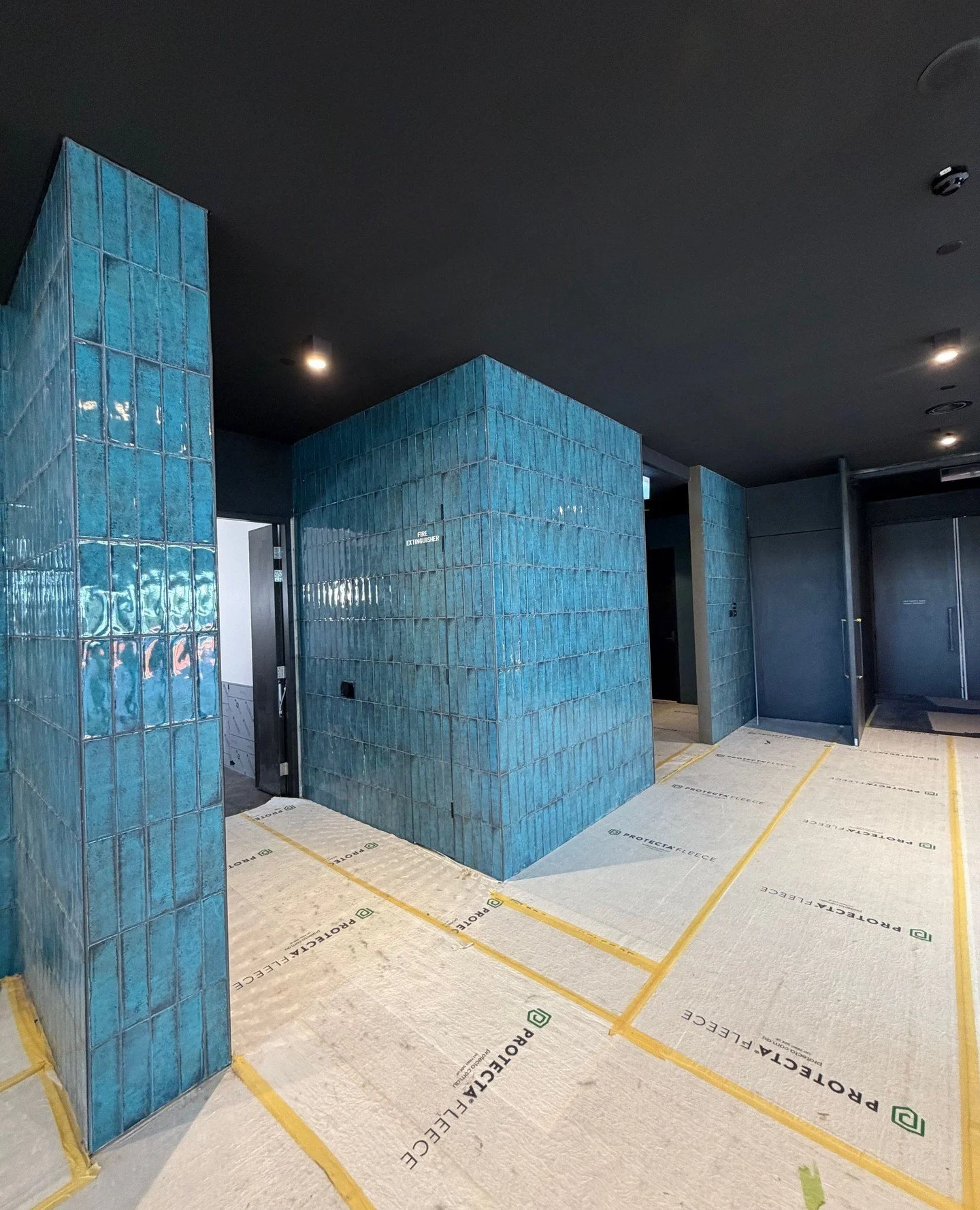 This striking tiled wall feature at the Busselton Performing Arts and Convention Centre is a real showstopper. The blue tones pop beautifully against the bold black feature ceilings, creating a space that feels both modern and dramatic.⁠
⁠
#ClassicCo