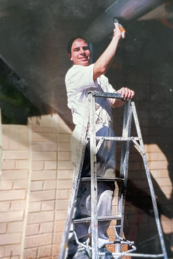 A young apprentice painter on the job.