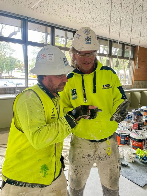 A deaf painter is given additional assistance with understanding instructions using a smart phone