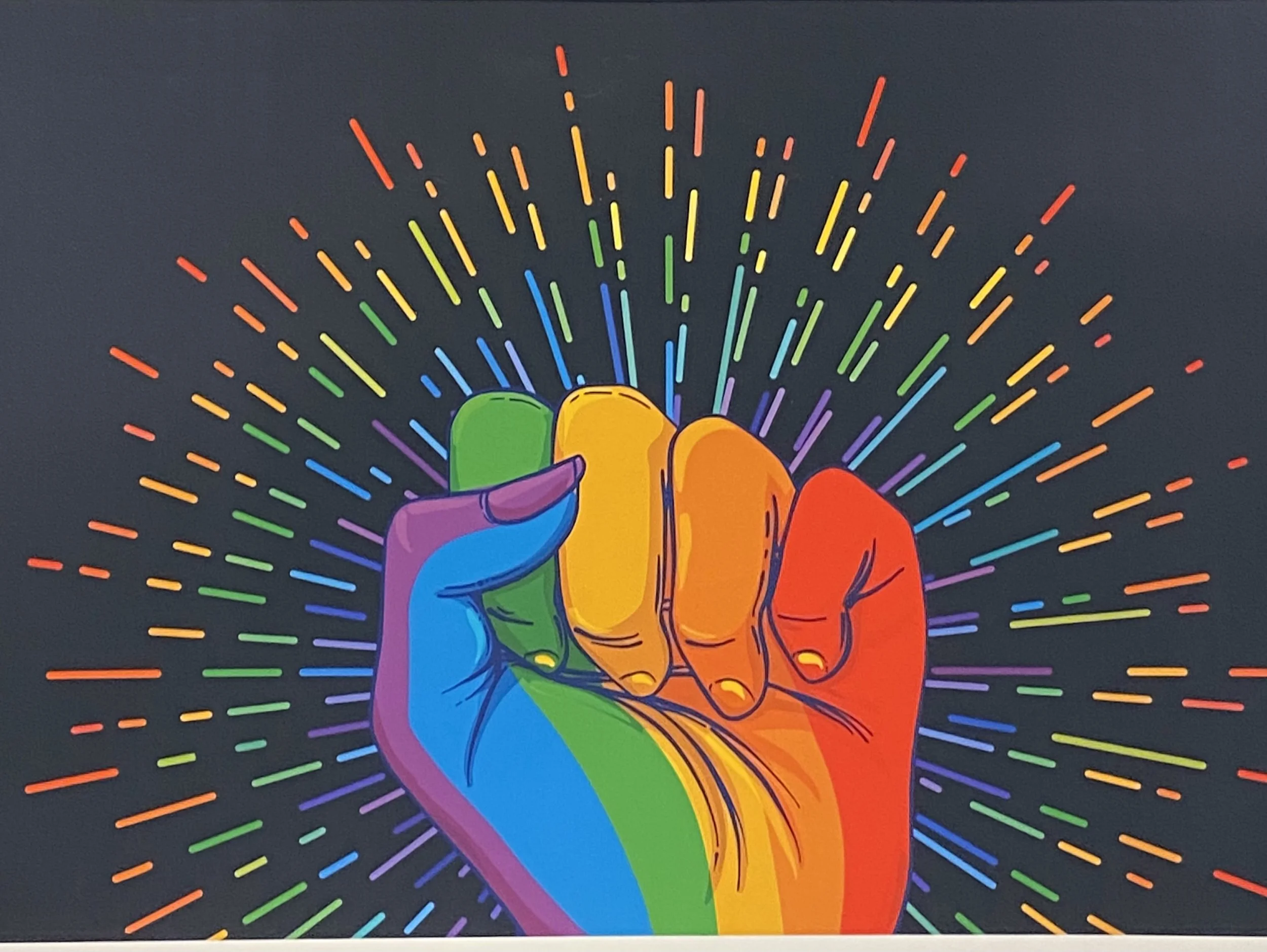 Graphic of multi-colored fist with rainbow colors rays