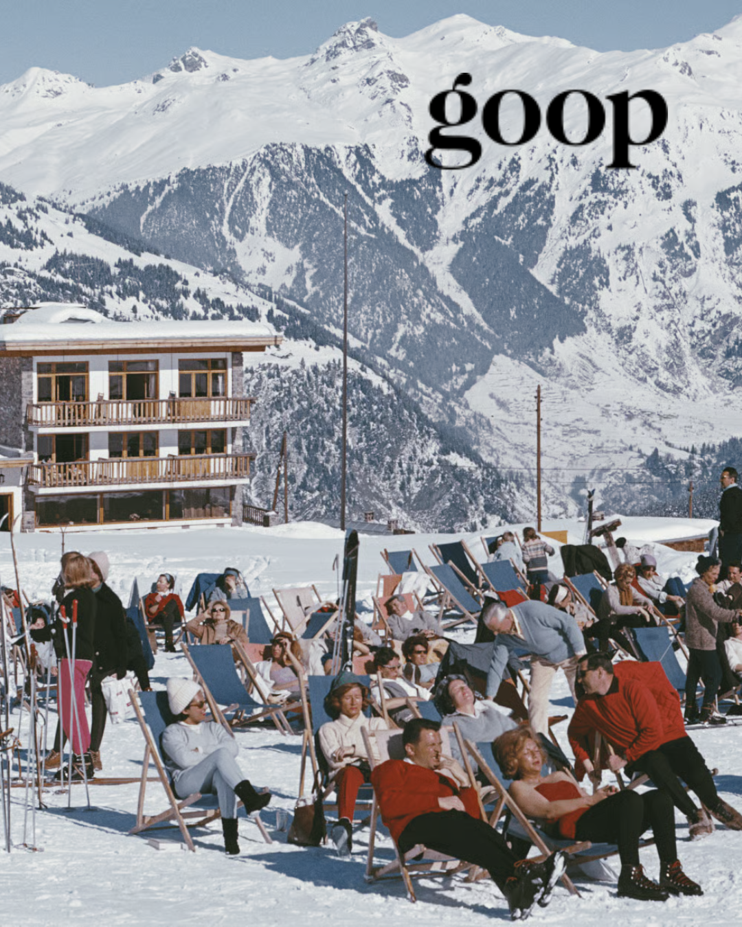 People sunbathing on deck chairs in snowy mountain resort with "goop" text overlay, building and snow-covered mountains in background.