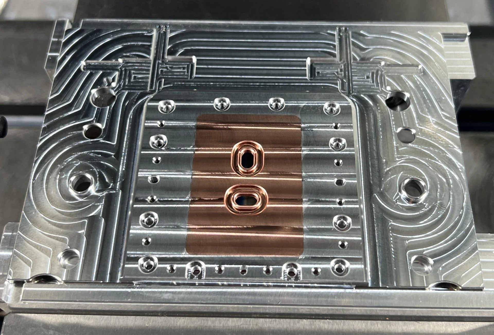 A Haas CNC Machined multi-material aluminum and copper soldered part.